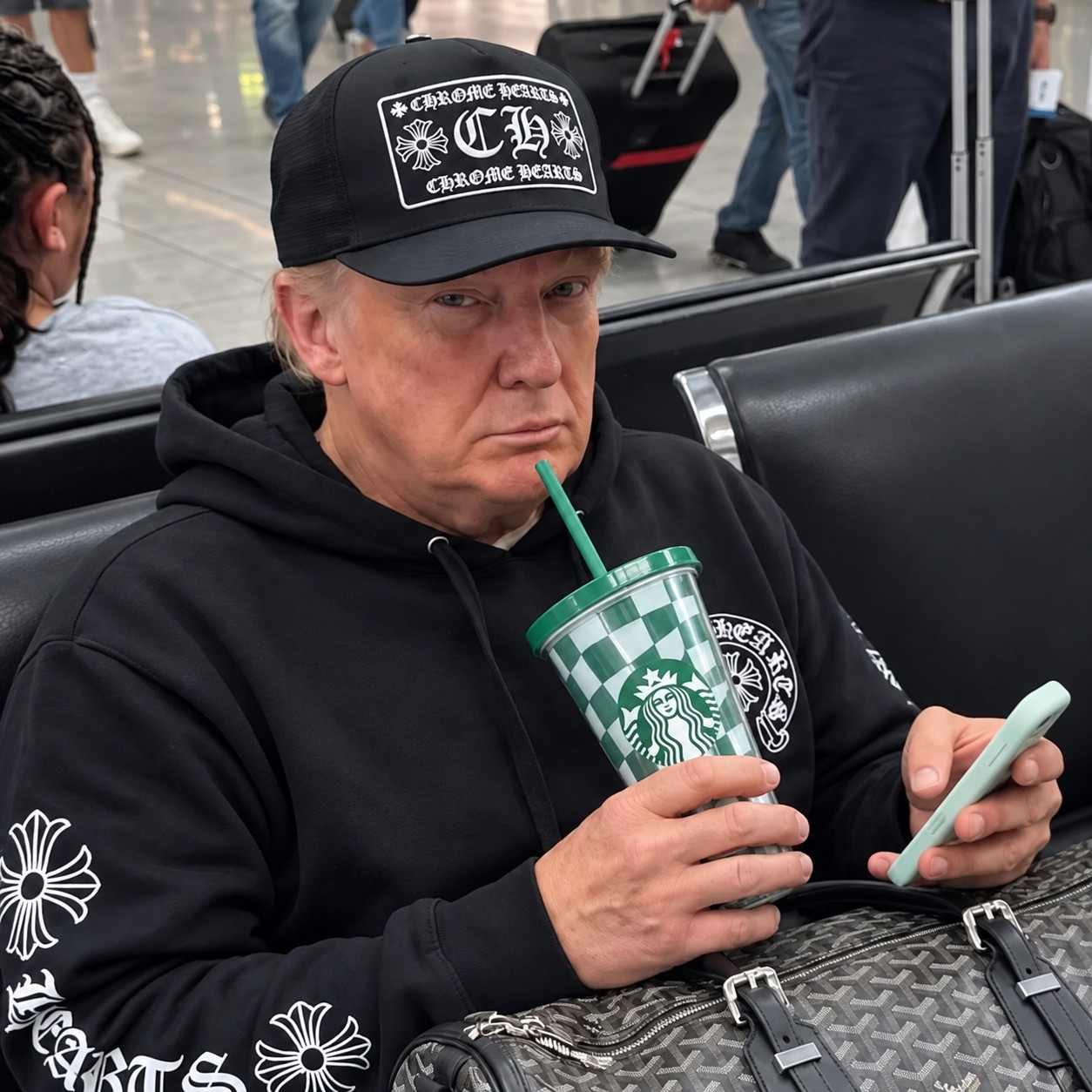 The H00D meme: a seated figure in a black cap and hoodie, holding a green drink.